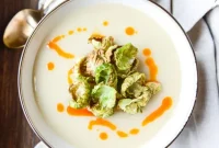 Creamy Roasted Garlic Potato Soup with Crispy Brussels & Chili Oil