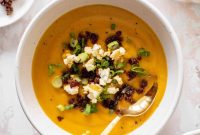 Spicy Honeynut Squash Soup Topped with Buttered Popcorn