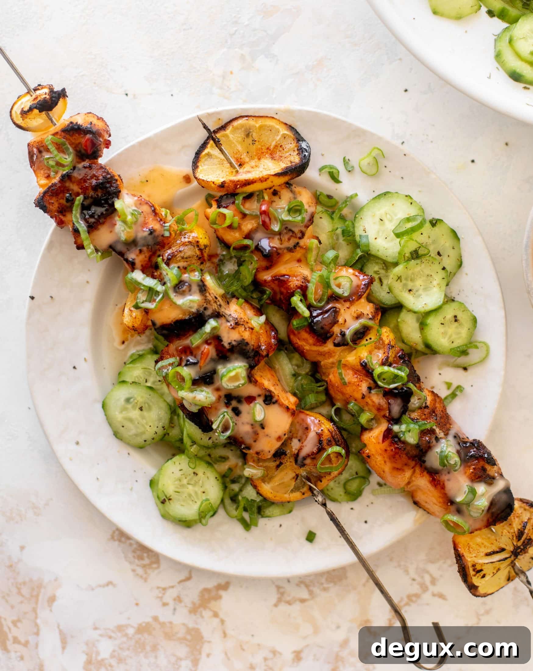 Grilled Bang Bang Salmon Skewers with Crisp Cucumber Salad 12 grilled bang bang salmon with cucumber salad