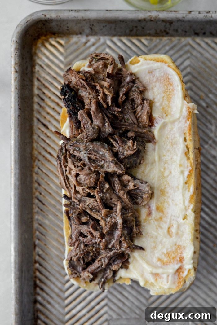 Slow-Cooker Mississippi Pot Roast Sandwich Recipe 7 top with pot roast