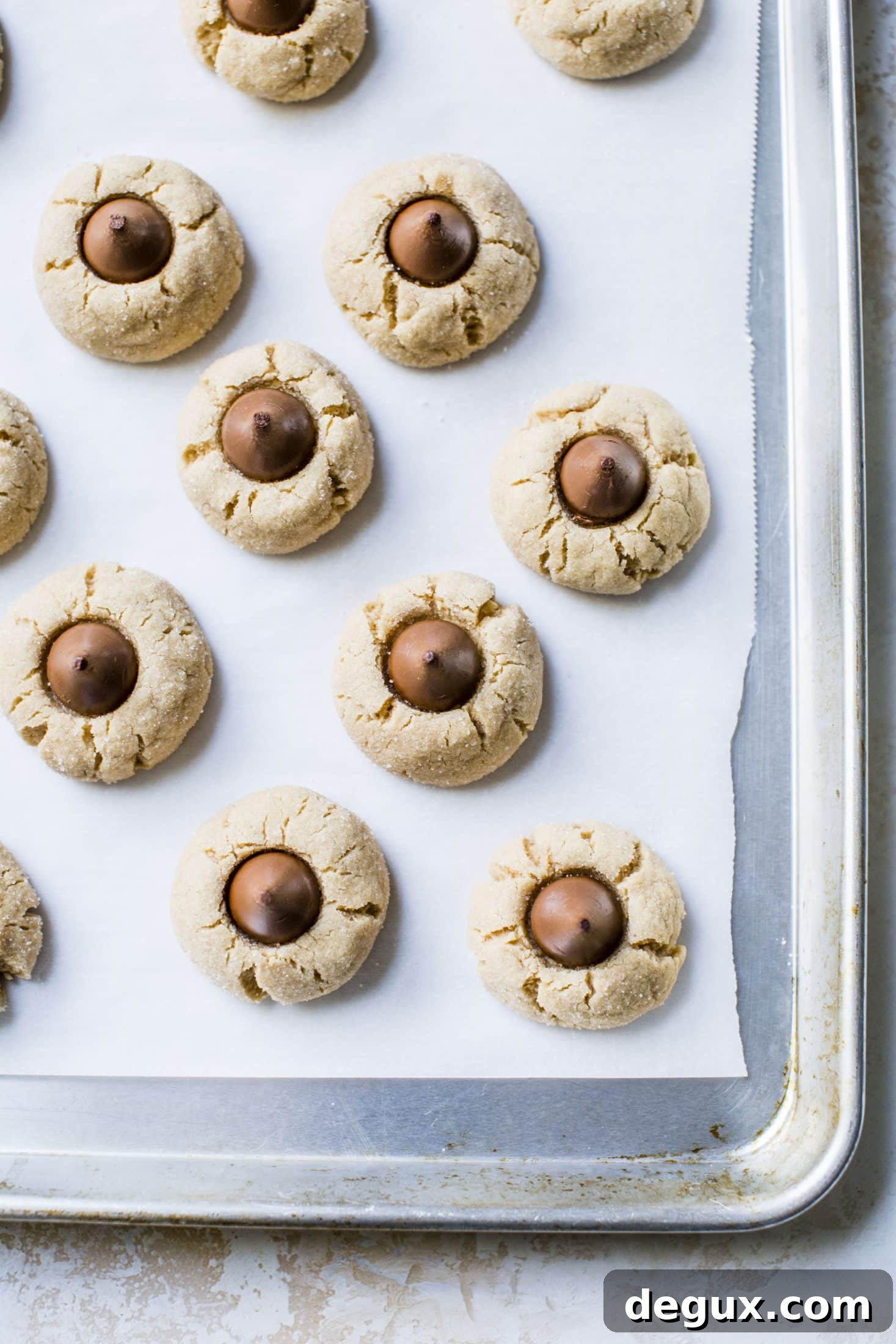 These are perfect peanut butter blossoms! My favorite cookie at christmastime has always been classic peanut butter blossoms and my grandma had the recipe nailed. These are super easy, delicious and will make a lot of cookies! I howsweeteats.com #peanutbutter #blossoms