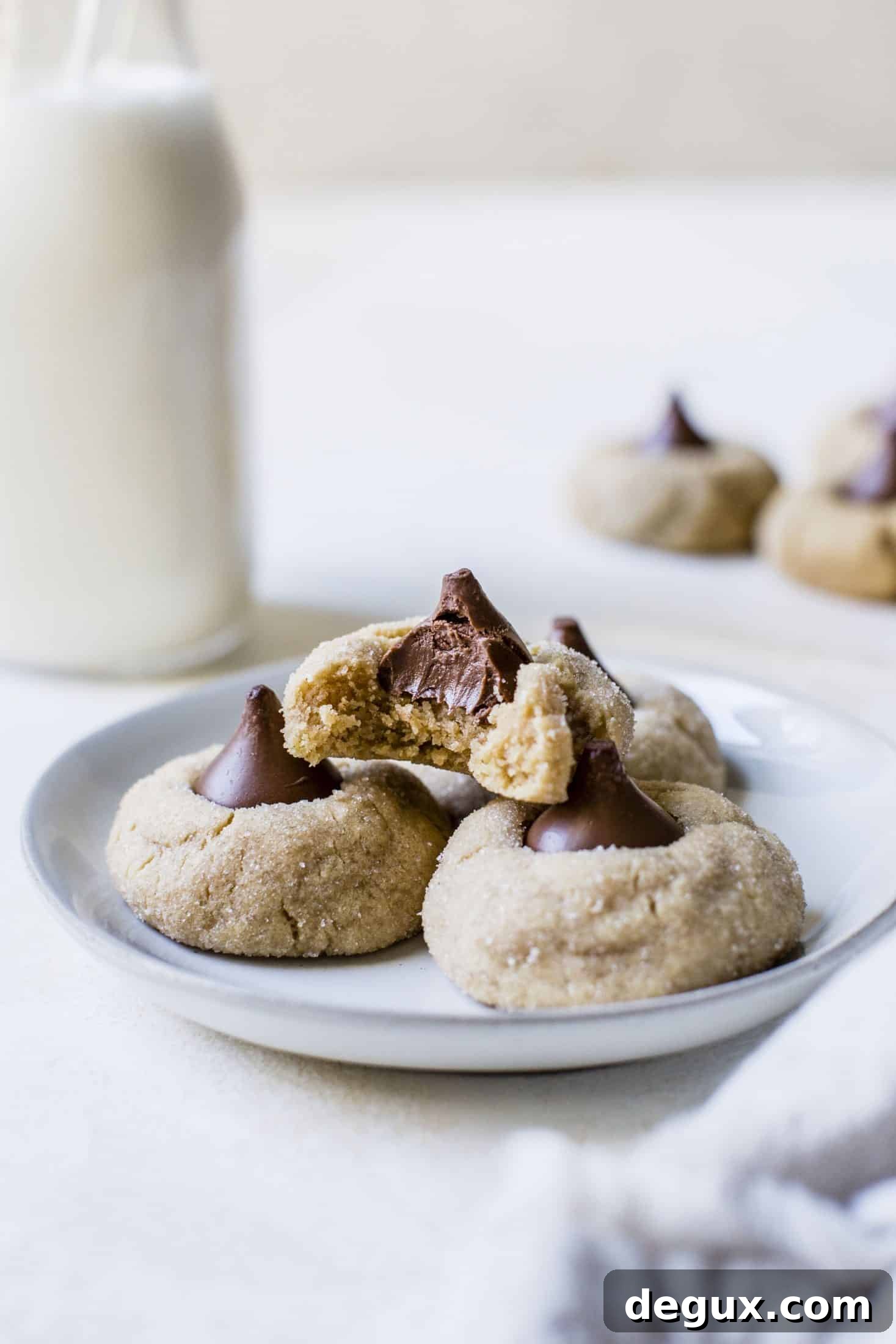 These are perfect peanut butter blossoms! My favorite cookie at christmastime has always been classic peanut butter blossoms and my grandma had the recipe nailed. These are super easy, delicious and will make a lot of cookies! I howsweeteats.com #peanutbutter #blossoms