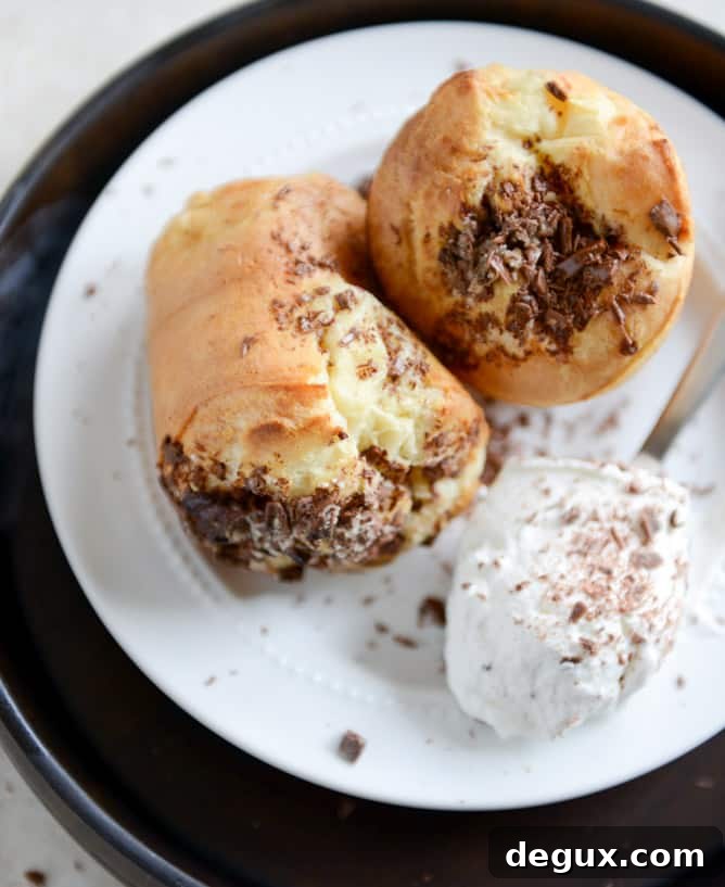 Dark Chocolate Chunk Popovers with Spiked Vanilla Bourbon Whipped Cream I howsweeteats.com Dark Chocolate Chunk Popovers with Spiked Vanilla Bourbon Whipped Cream I howsweeteats.com