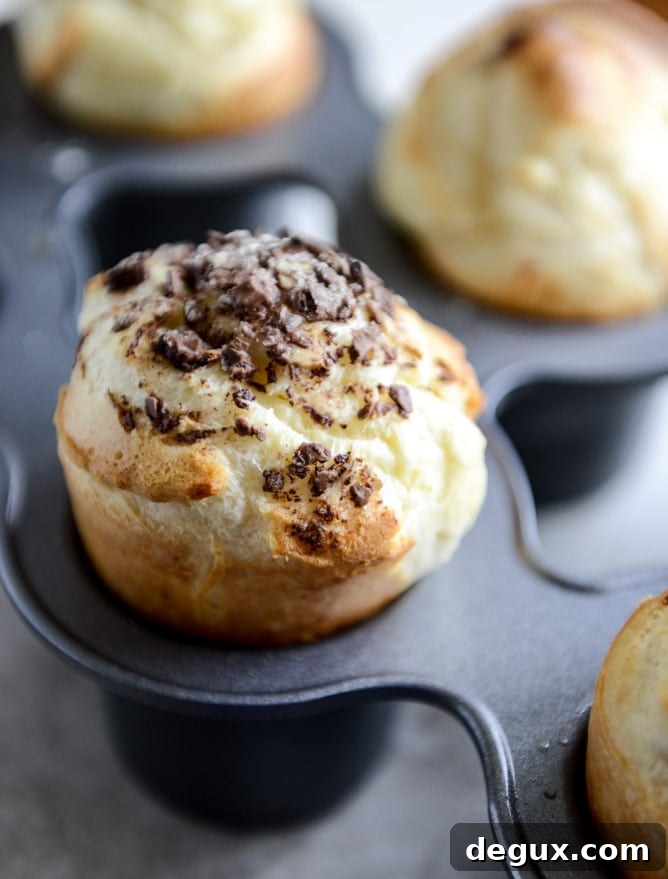 Dark Chocolate Chunk Popovers with Spiked Vanilla Bourbon Whipped Cream I howsweeteats.com Dark Chocolate Chunk Popovers with Spiked Vanilla Bourbon Whipped Cream I howsweeteats.com