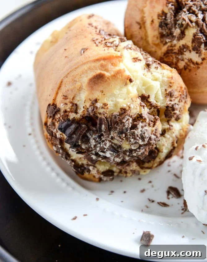 Dark Chocolate Chunk Popovers with Spiked Vanilla Bourbon Whipped Cream I howsweeteats.com Dark Chocolate Chunk Popovers with Spiked Vanilla Bourbon Whipped Cream I howsweeteats.com