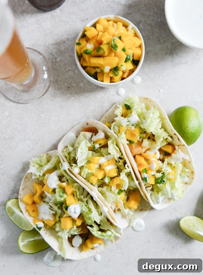 Beer Battered Fish Tacos with Mango Margarita Salsa and Jalapeño Crema I howsweeteats.com