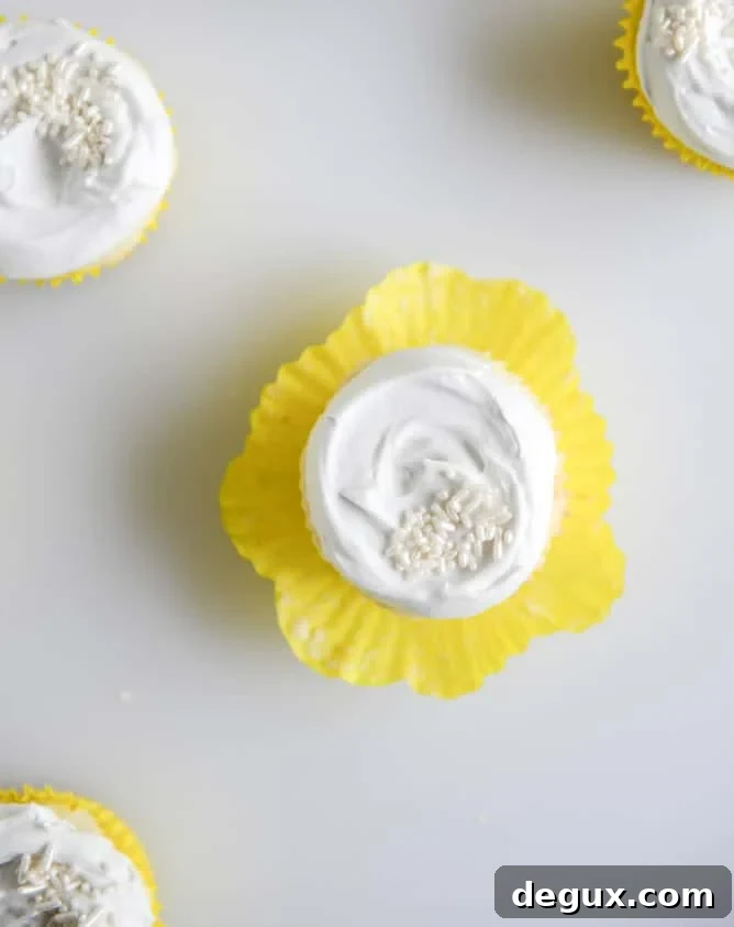 Fluffy Lemon Cupcakes with Whipped Coconut Cream I howsweeteats.com