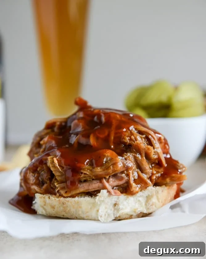 Juicy Pulled Pork Sandwich Recipe with Tangy BBQ Sauce 2 saucy pulled pork sandwiches I howsweeteats.com