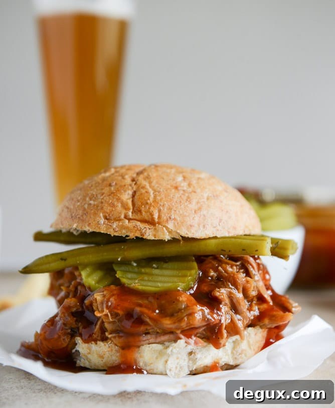 Juicy Pulled Pork Sandwich Recipe with Tangy BBQ Sauce 3 saucy pulled pork sandwiches I howsweeteats.com