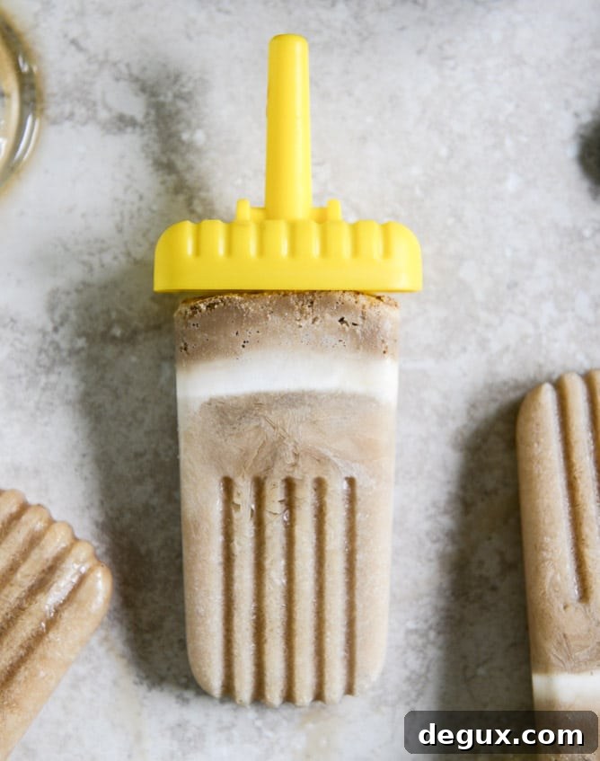 Root Beer Float Popsicles: Creamy Homemade Summer Treats 2 root beer floatsicles I howsweeteats.com