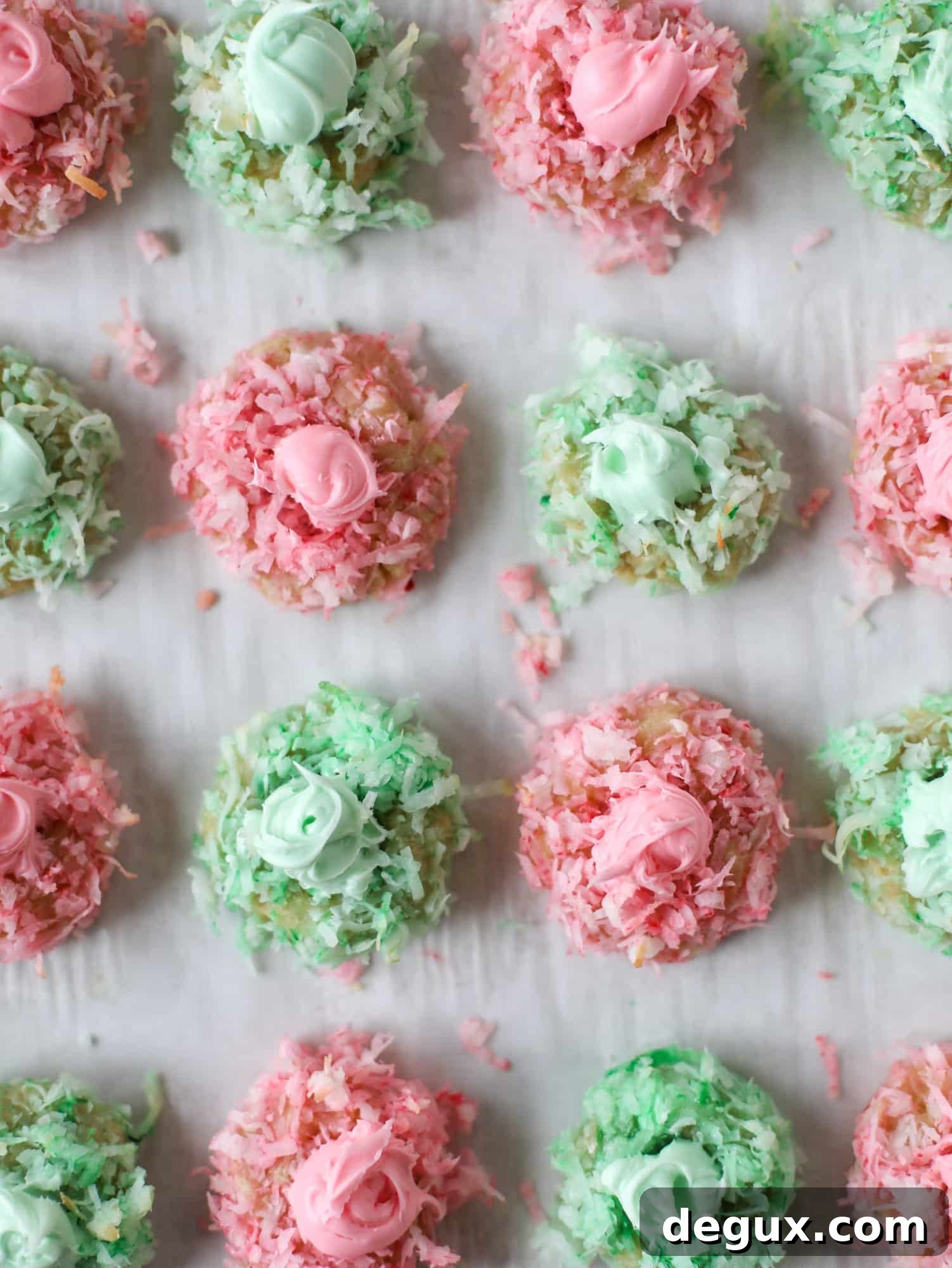 These thumbprint cookies are so perfect for the holiday season. The best butter thumbprint rolled in pink and green coconut and filled with buttercream. So festive! I personally think they look like Grinch cookies - kids love them! I howsweeteats.com #thumbprint #cookies