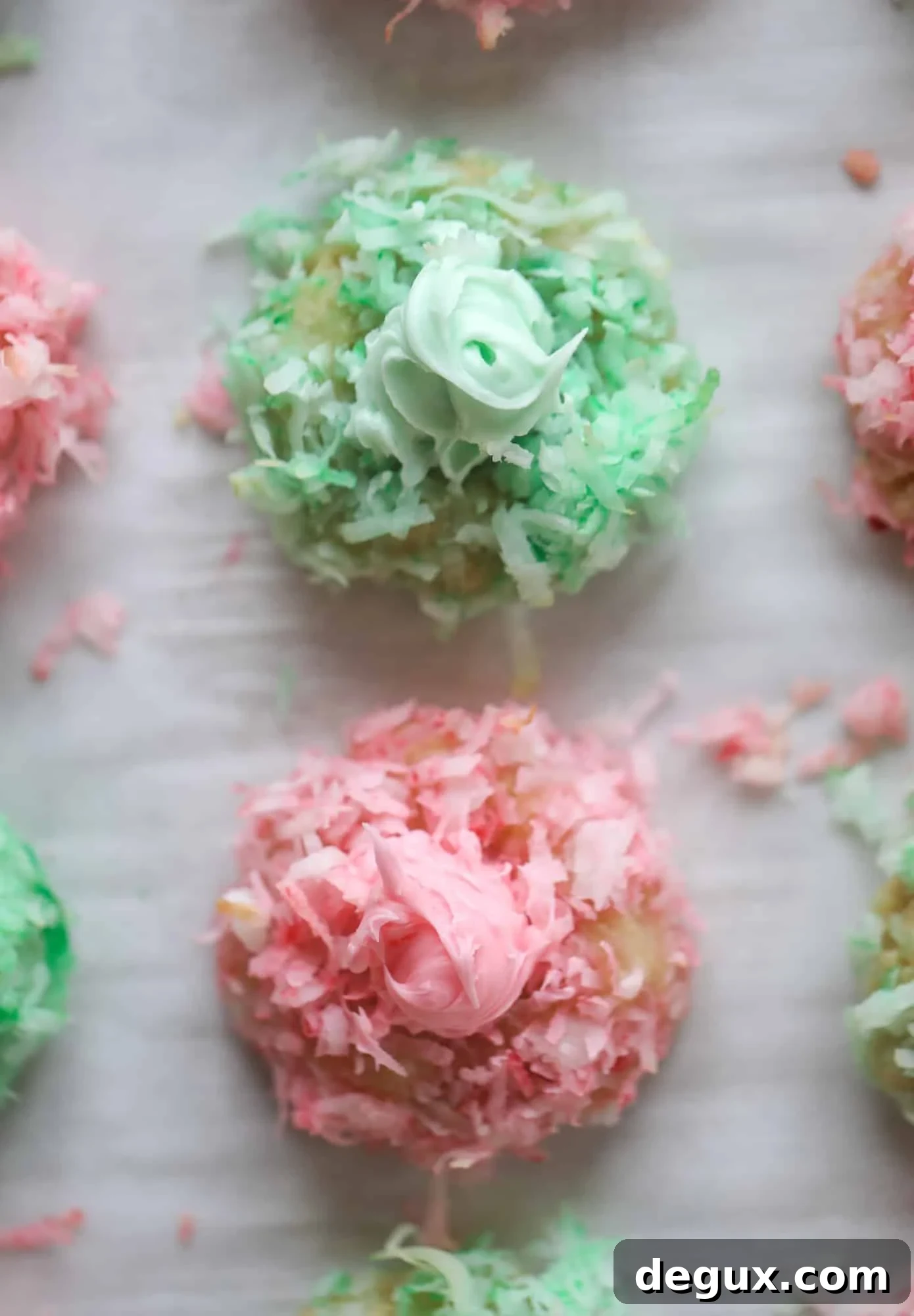 These thumbprint cookies are so perfect for the holiday season. The best butter thumbprint rolled in pink and green coconut and filled with buttercream. So festive! I personally think they look like Grinch cookies - kids love them! I howsweeteats.com #thumbprint #cookies
