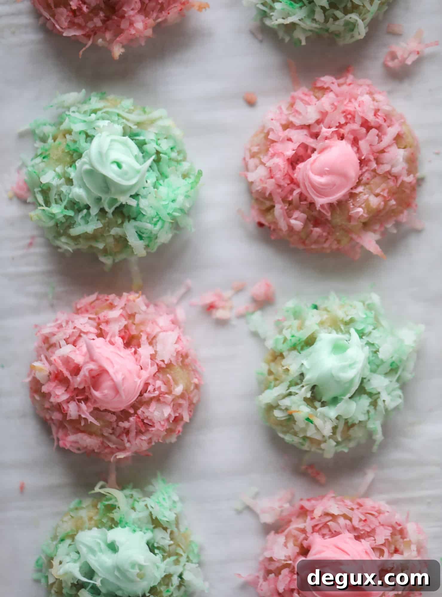 These thumbprint cookies are so perfect for the holiday season. The best butter thumbprint rolled in pink and green coconut and filled with buttercream. So festive! I personally think they look like Grinch cookies - kids love them! I howsweeteats.com #thumbprint #cookies