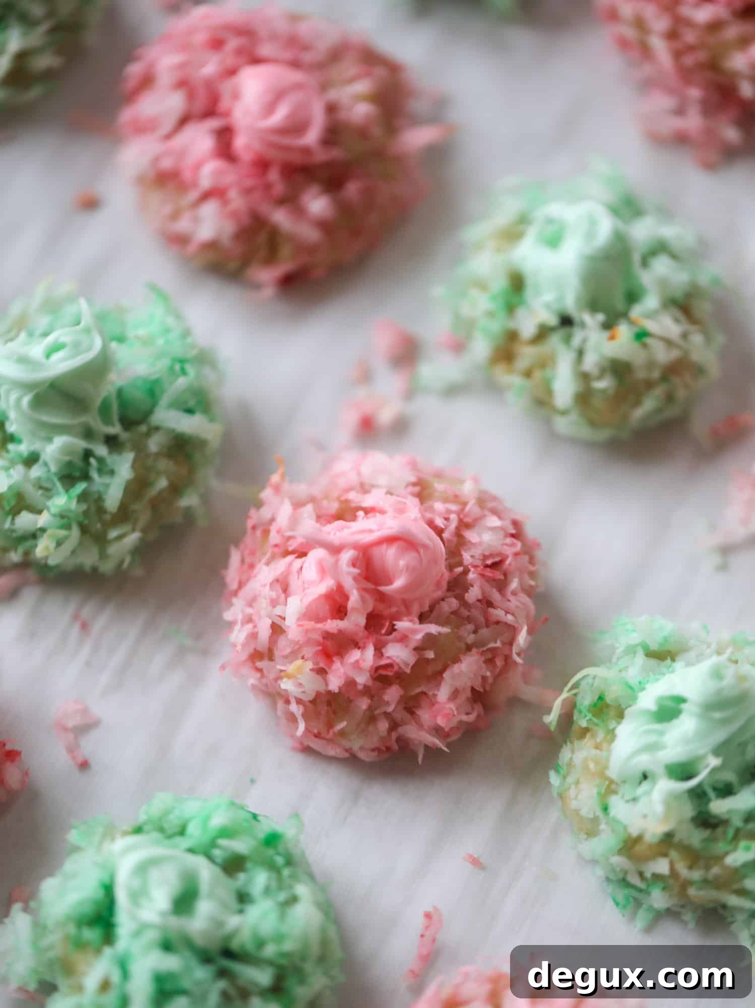 These thumbprint cookies are so perfect for the holiday season. The best butter thumbprint rolled in pink and green coconut and filled with buttercream. So festive! I personally think they look like Grinch cookies - kids love them! I howsweeteats.com #thumbprint #cookies