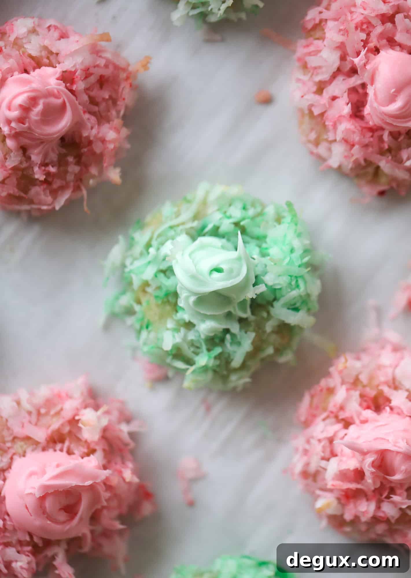 These thumbprint cookies are so perfect for the holiday season. The best butter thumbprint rolled in pink and green coconut and filled with buttercream. So festive! I personally think they look like Grinch cookies - kids love them! I howsweeteats.com #thumbprint #cookies