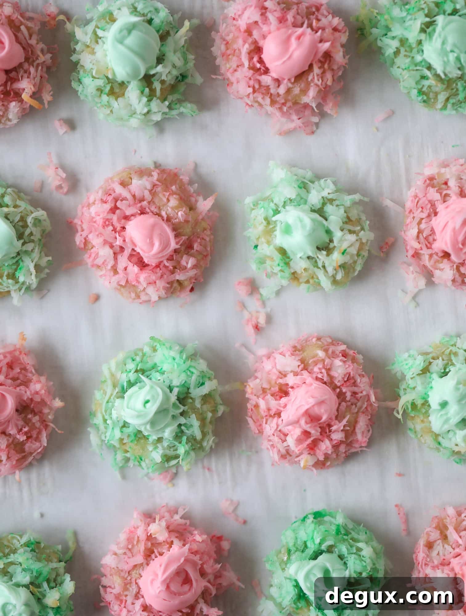 These thumbprint cookies are so perfect for the holiday season. The best butter thumbprint rolled in pink and green coconut and filled with buttercream. So festive! I personally think they look like Grinch cookies - kids love them! I howsweeteats.com #thumbprint #cookies