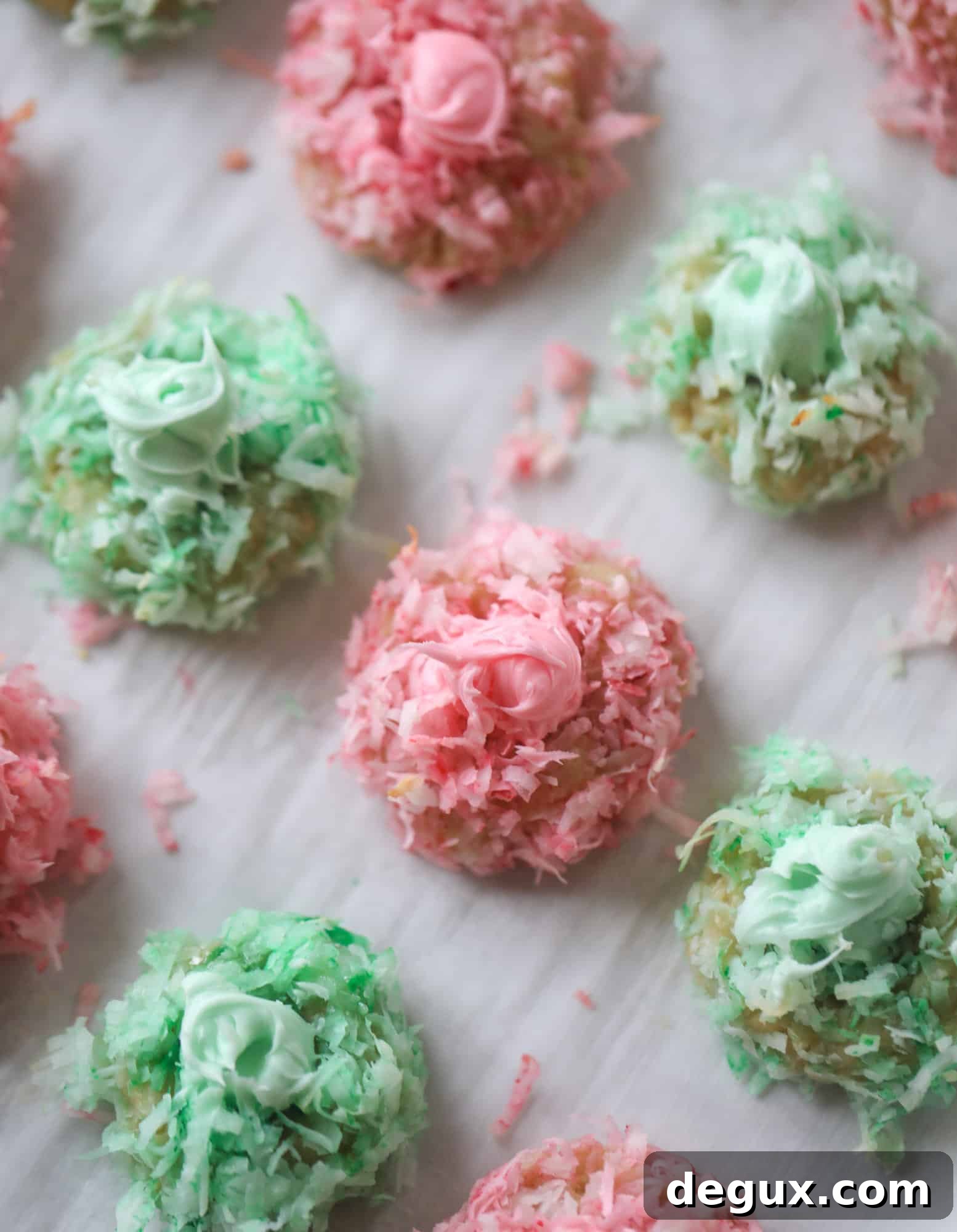 These thumbprint cookies are so perfect for the holiday season. The best butter thumbprint rolled in pink and green coconut and filled with buttercream. So festive! I personally think they look like Grinch cookies - kids love them! I howsweeteats.com #thumbprint #cookies