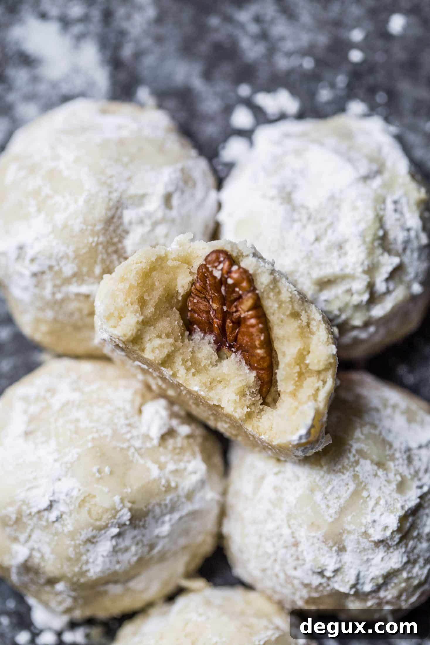 These classic butterball cookies are a favorite that my grandmother made every year at Christmas. They are a light cookie that isn't super sweet and the center is filled with either a pecan or maraschino cherry. Classic and delicious! I howsweeteats.com #butterball #cookies