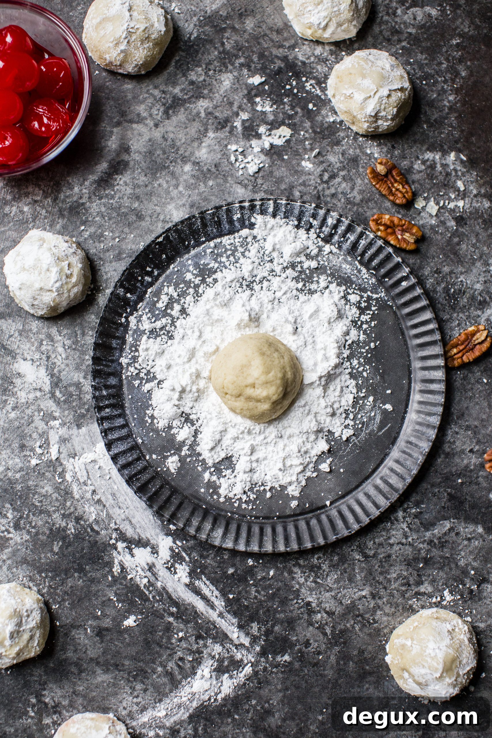 These classic butterball cookies are a favorite that my grandmother made every year at Christmas. They are a light cookie that isn't super sweet and the center is filled with either a pecan or maraschino cherry. Classic and delicious! I howsweeteats.com #butterball #cookies