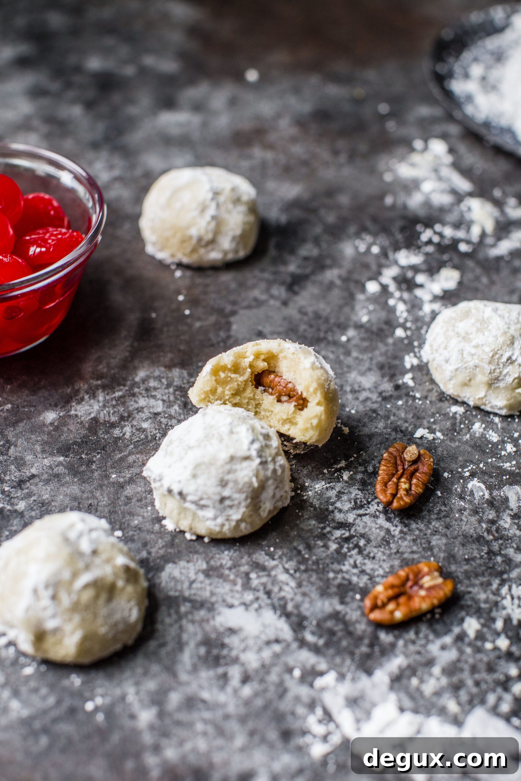 These classic butterball cookies are a favorite that my grandmother made every year at Christmas. They are a light cookie that isn't super sweet and the center is filled with either a pecan or maraschino cherry. Classic and delicious! I howsweeteats.com #butterball #cookies