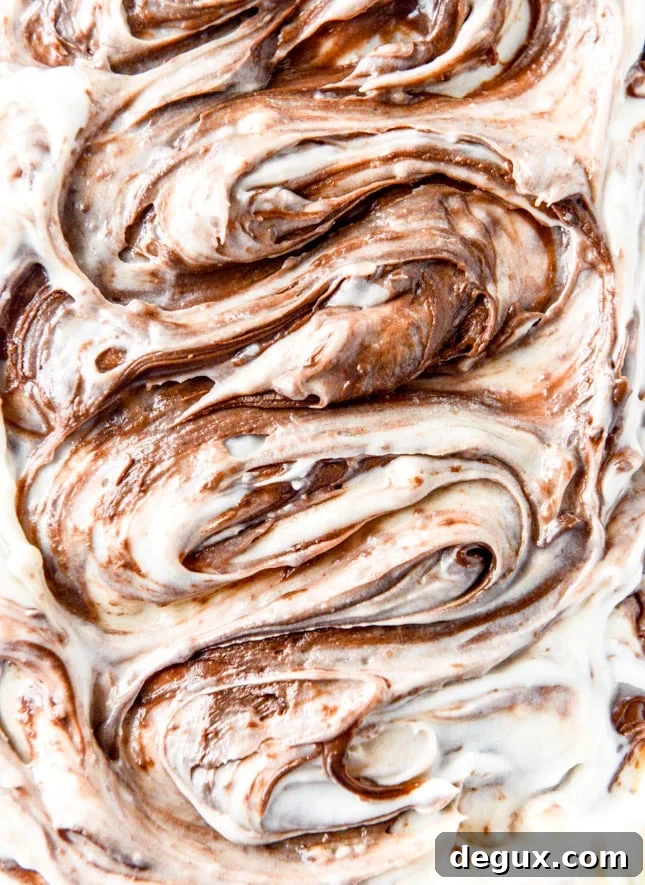 carrot cake cake with nutella swirled cream cheese frosting I howsweeteats.com