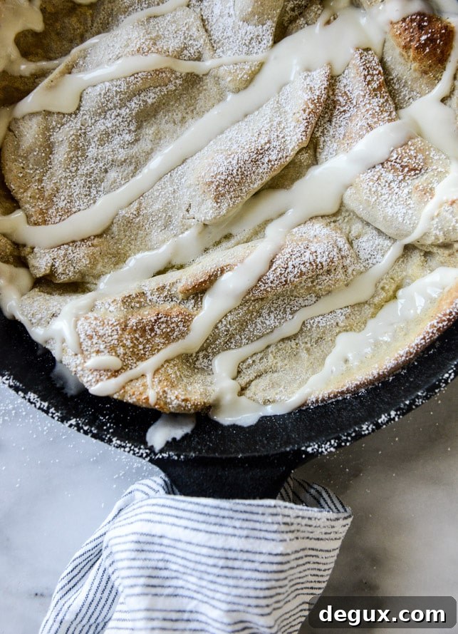 Vanilla Cinnamon Roll Dutch Baby with Apple Bourbon Compote & Cream Cheese Icing 4 vanilla cinnamon roll dutch baby with apple bourbon compote and cream cheese icing I howsweeteats.com