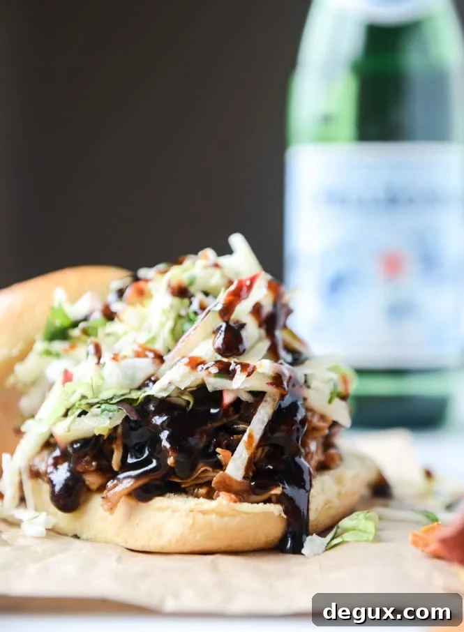 Pomegranate BBQ Chicken Sandwiches with Crunchy Apple Slaw 2 saucy chicken sandwiches with pomegranate bbq sauce and crunchy apple slaw I howsweeteats.com