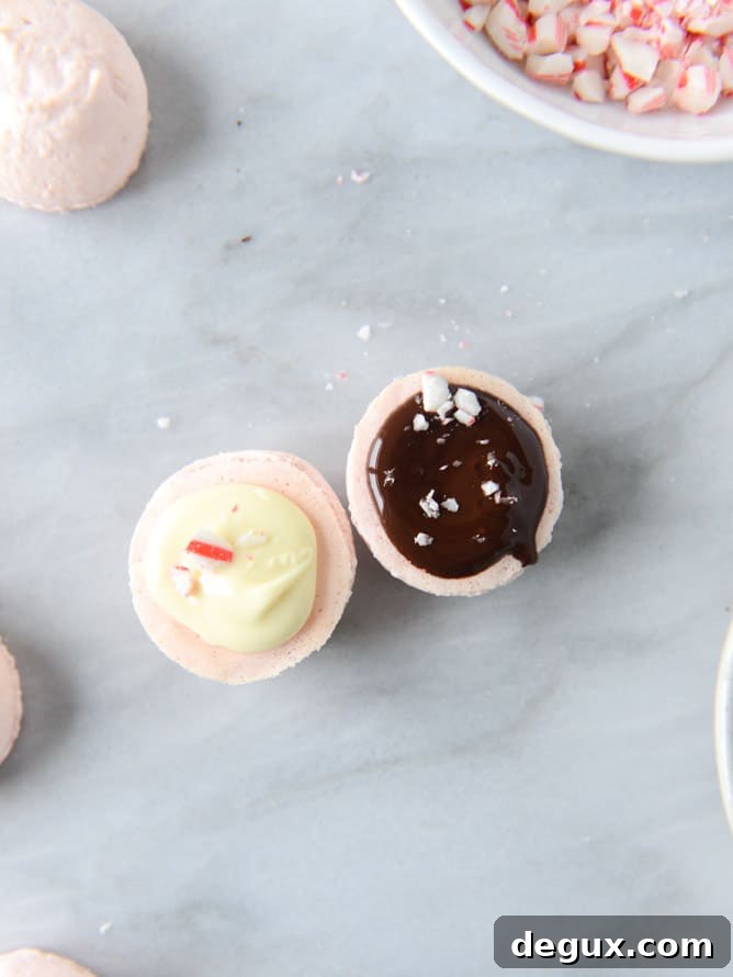 Pink Peppermint Bark Macarons Recipe — Festive Holiday Dessert 3 pink peppermint bark macarons I howsweeteats.com