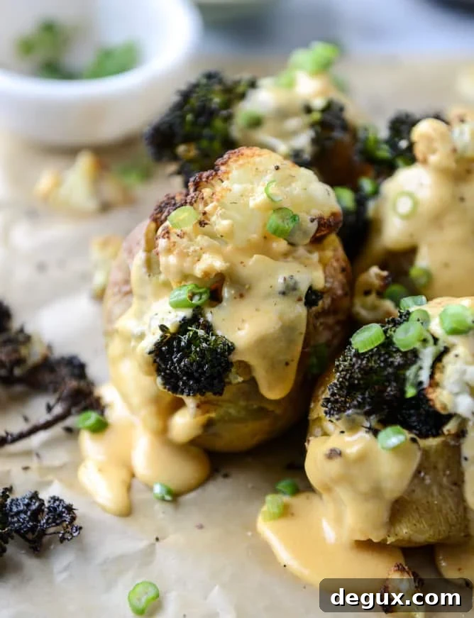 Roasted Cauliflower & Broccoli Stuffed Potatoes with Cheesy Butternut Sauce 2 stuffed potatoes with butternut cheese sauce I howsweeteats.com