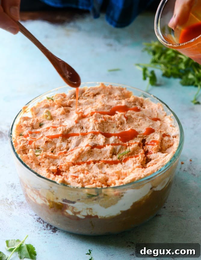 Layered Buffalo Chicken Dip Recipe: Creamy, Cheesy Party Dip 5 layered buffalo chicken dip I howsweeteats.com