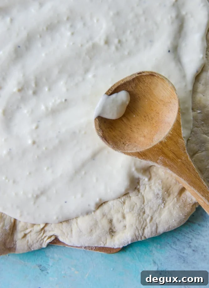white pizza with garlic sauce and garden herbs I howsweeteats.com