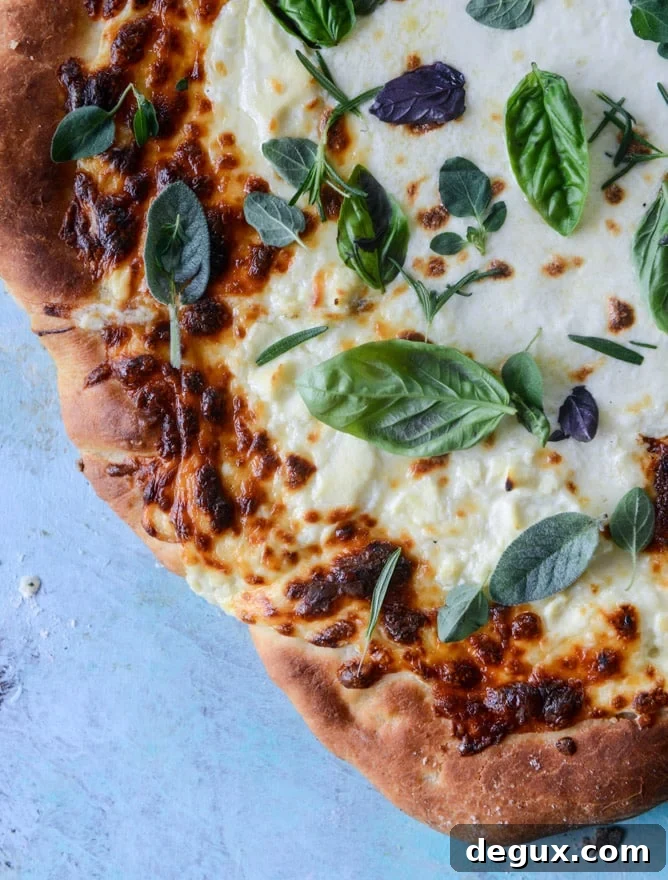 white pizza with garlic sauce and garden herbs I howsweeteats.com