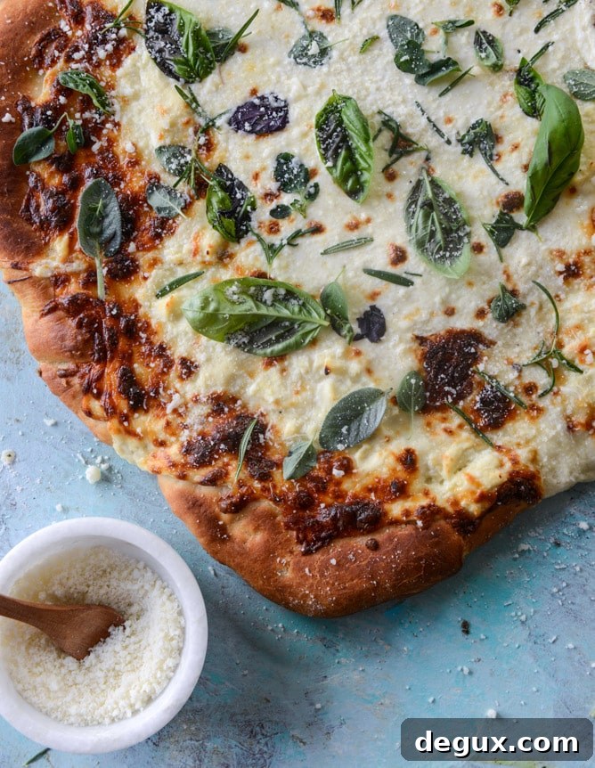 white pizza with garlic sauce and garden herbs I howsweeteats.com