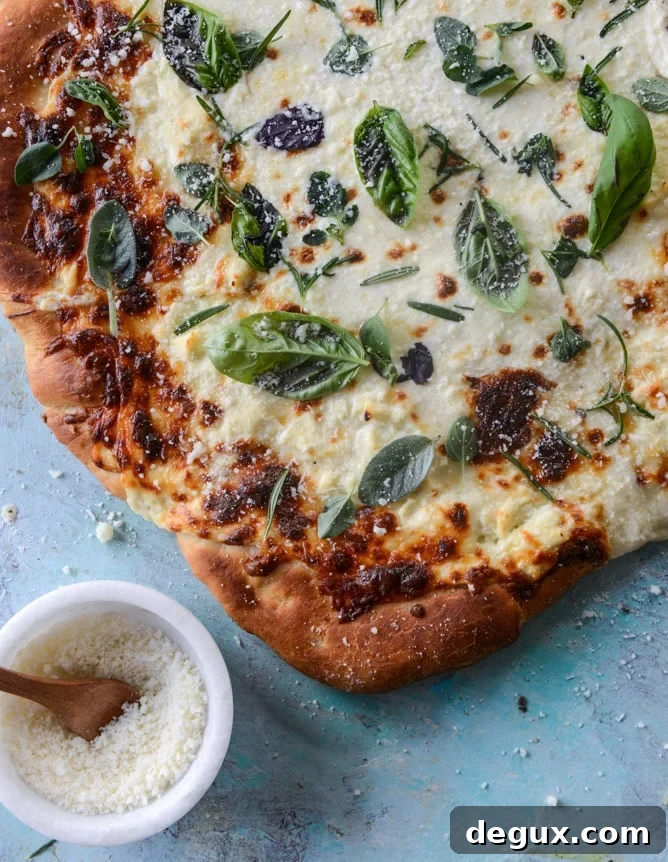white pizza with garlic sauce and garden herbs I howsweeteats.com