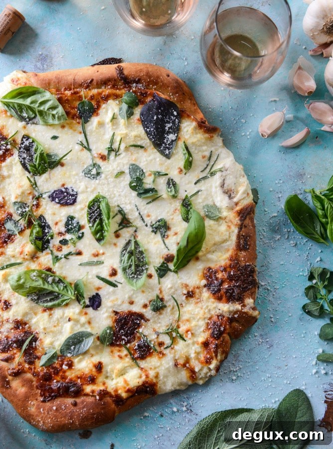 white pizza with garlic sauce and garden herbs I howsweeteats.com
