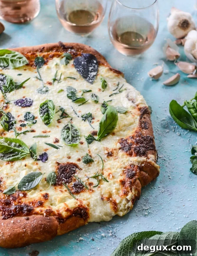 white pizza with garlic sauce and garden herbs I howsweeteats.com