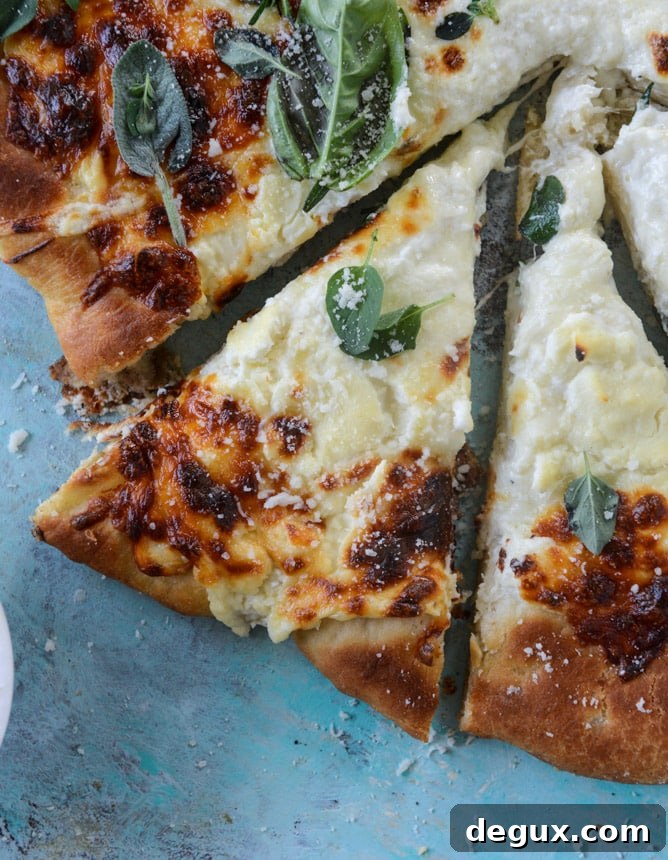white pizza with garlic sauce and garden herbs I howsweeteats.com