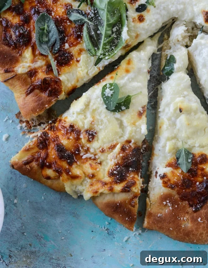 white pizza with garlic sauce and garden herbs I howsweeteats.com