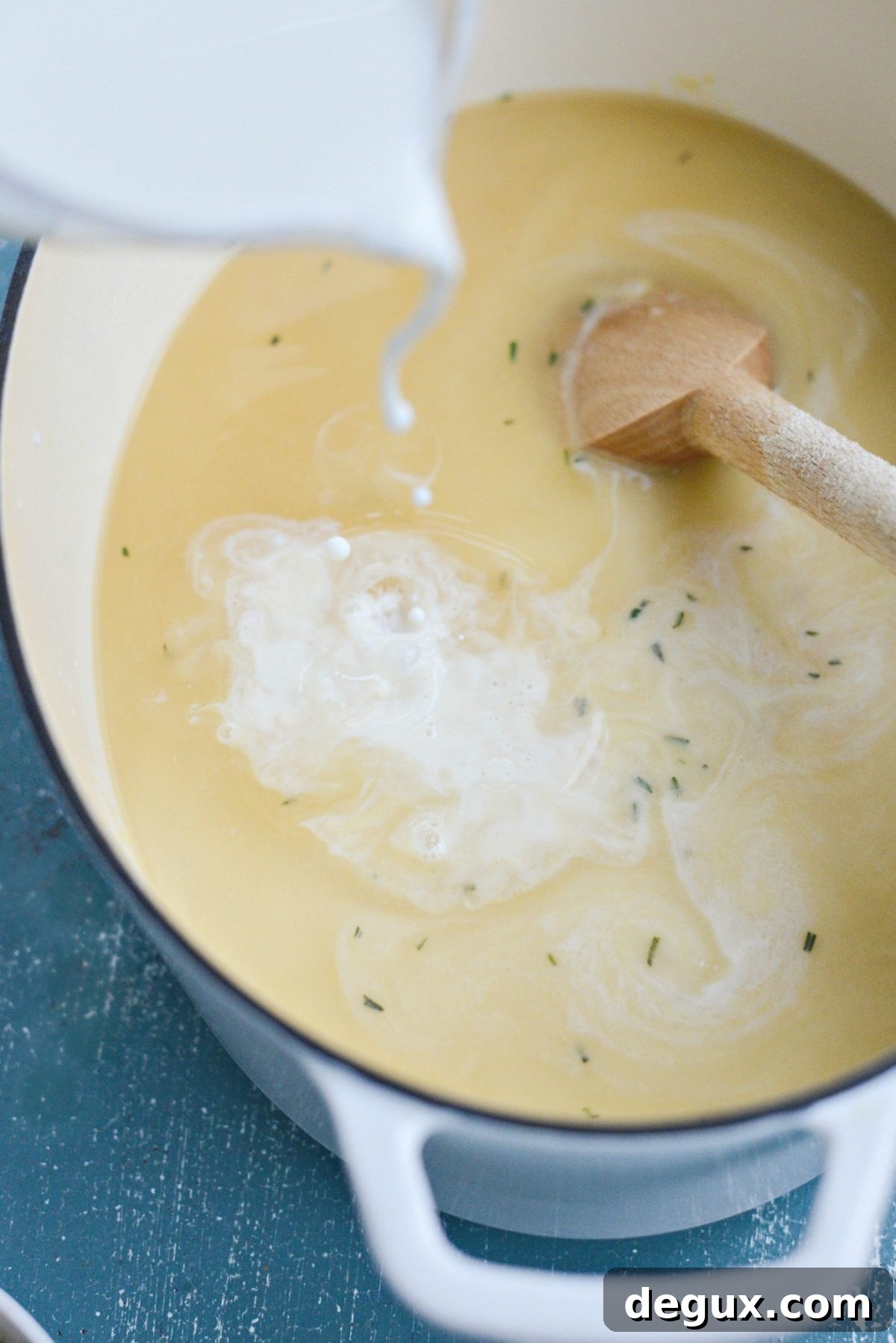 Homemade Turkey and Wild Rice Soup Recipe for Leftovers 10 pouring half and half with turkey stock into the pot.