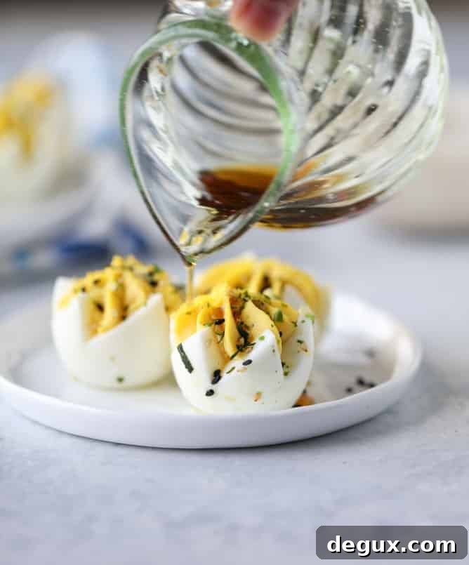 Toasted Sesame Sriracha Deviled Eggs Recipe 8 toasted sesame sriracha deviled eggs I howsweeteats.com
