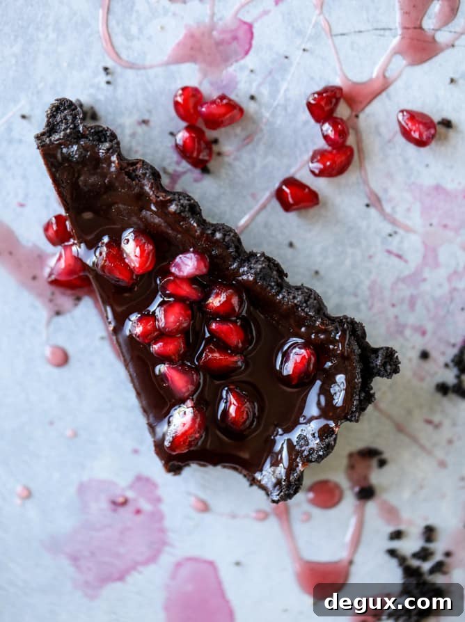 dark chocolate fudge pomegranate tart I howsweeteats.com #chocolate #pomegranate #dessert