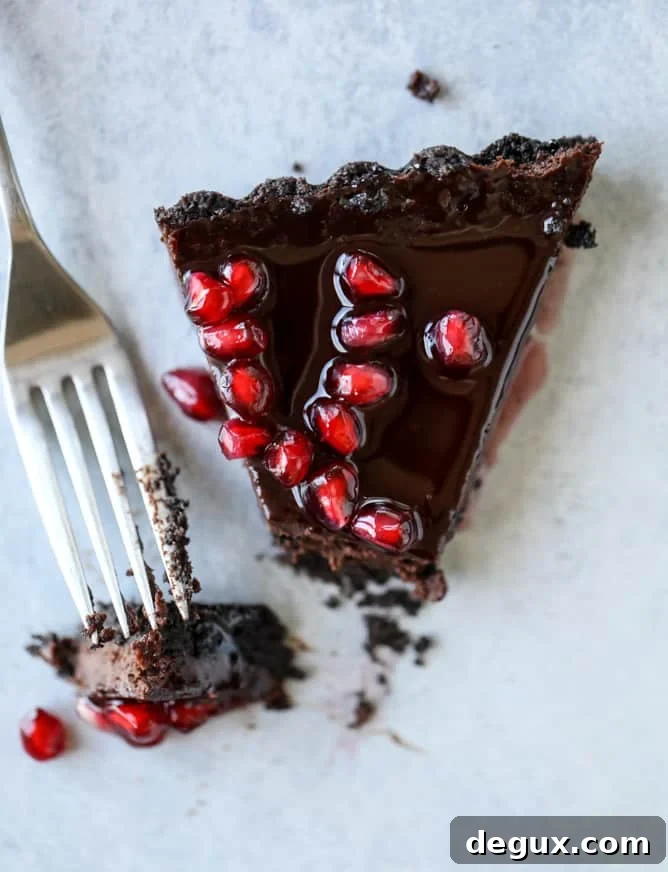dark chocolate fudge pomegranate tart I howsweeteats.com #chocolate #pomegranate #dessert