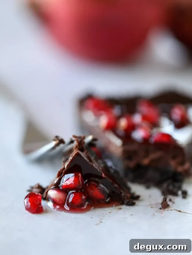 dark chocolate fudge pomegranate tart I howsweeteats.com #chocolate #pomegranate #dessert
