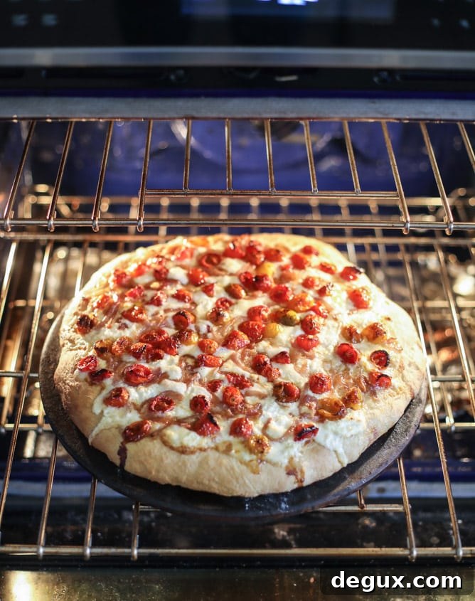 Slow-Roasted Cherry Tomato Pizza with Garlic Cream and Arugula 10 slow roasted cherry tomato pizza with garlic cream and arugula I howsweeteats.com #pizza #recipes