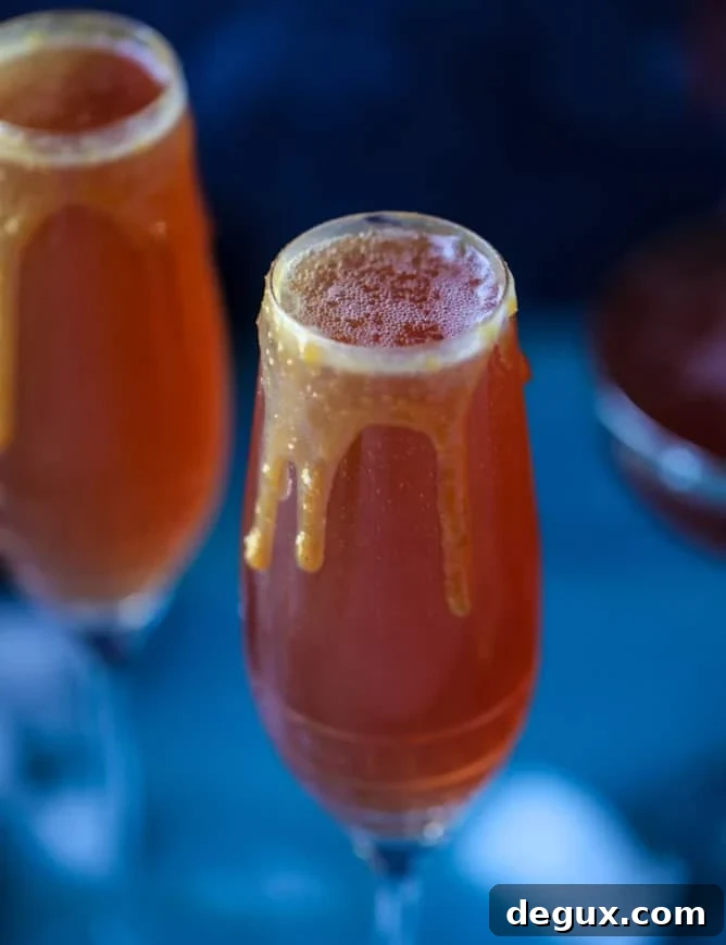 pomegranate cider mimosas with a salted caramel rim I howsweeteats.com #cocktails #thanksgiving #applecider #mimosas