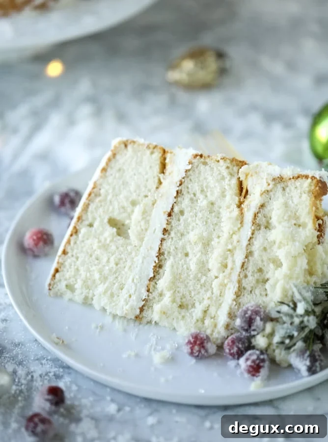 Winter White Sparkle Cake: Festive Snowflake Dessert Recipe 12 white christmas sparkle cake I howsweeteats.com #christmas #cake #vanilla #almond