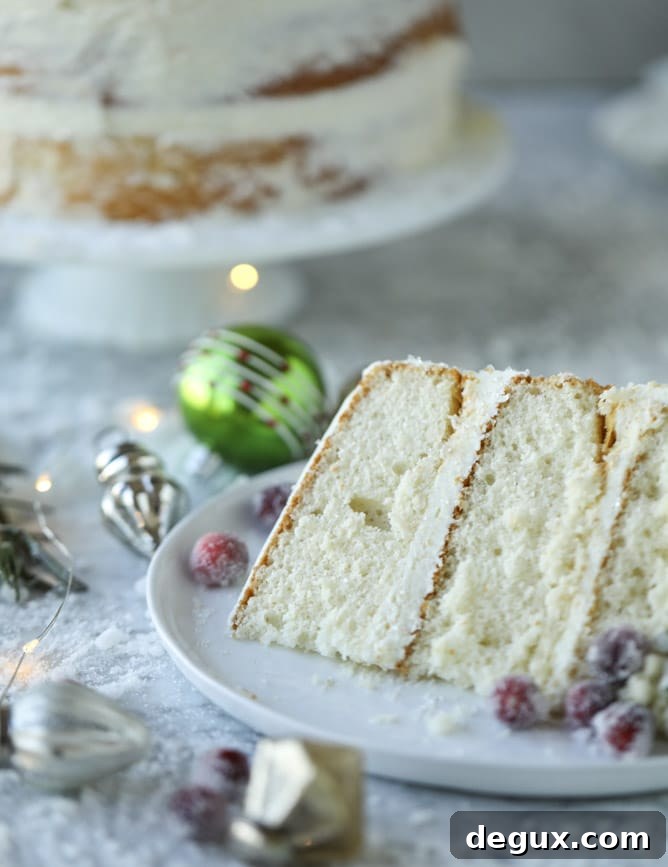 Winter White Sparkle Cake: Festive Snowflake Dessert Recipe 8 white christmas sparkle cake I howsweeteats.com #christmas #cake #vanilla #almond