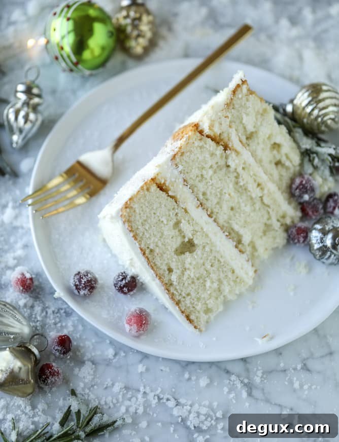 Winter White Sparkle Cake: Festive Snowflake Dessert Recipe 9 white christmas sparkle cake I howsweeteats.com #christmas #cake #vanilla #almond