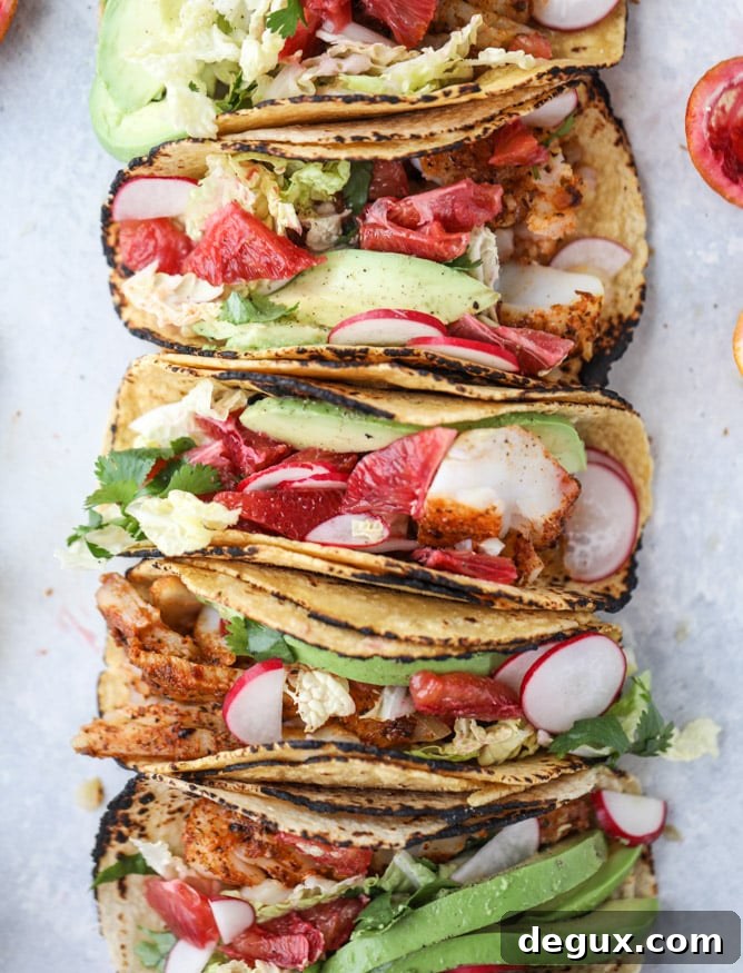 Cajun Fish Tacos with Zesty Blood Orange Slaw 2 cajun fish tacos with blood orange slaw I howsweeteats.com #fishtacos #tacos #bloodorange #fish
