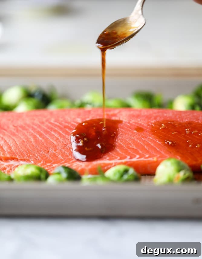 sheet pan honey garlic salmon and brussels I howsweeteats.com #sheetpan #salmon #honeygarlic #brusselssprouts